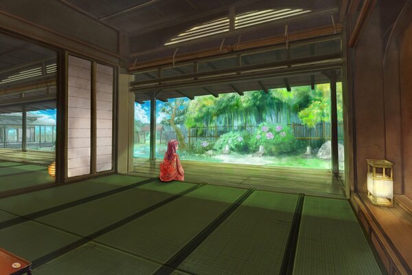 Asian girl in kimono looks at the garden