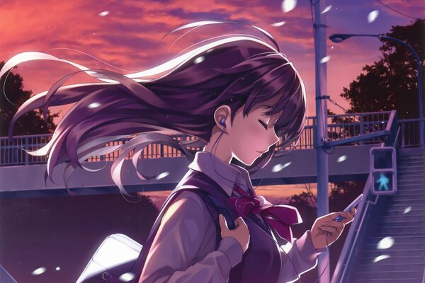 Schoolgirl wearing headphones at sunset