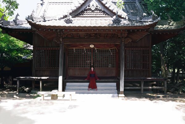 Mädchen im roten Kimono auf den Stufen