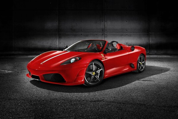 A red Ferrari f430 stands on a black and gray background