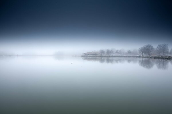 Mysterious morning fog on the lake