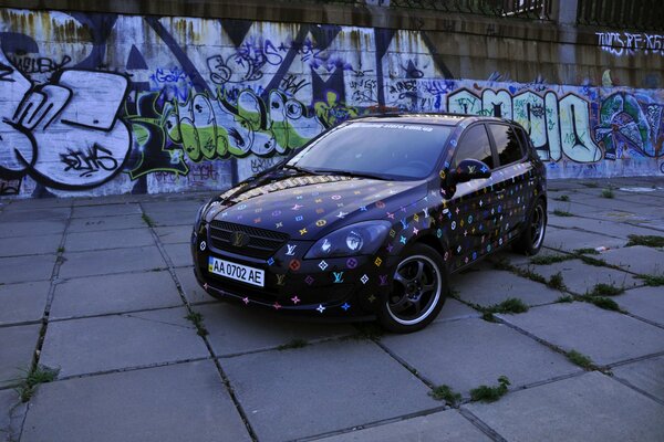 Kia car on the background of colored graffiti