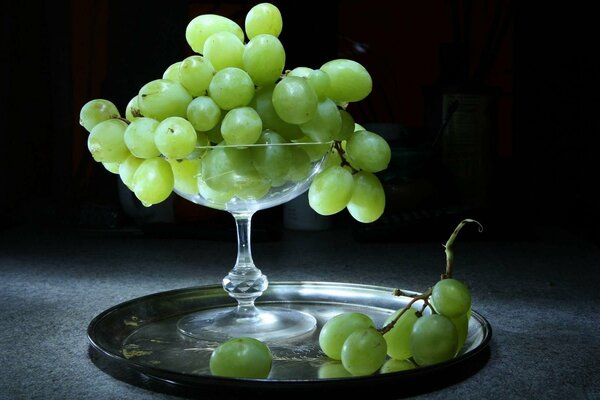 Grapes in a vase on a tray