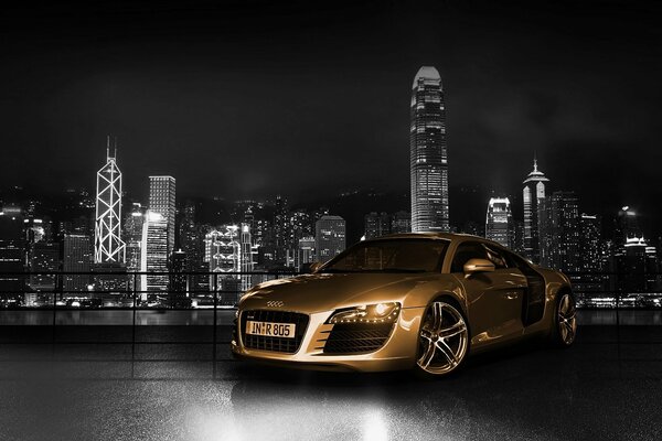 Audi in gold color on the background of the night city
