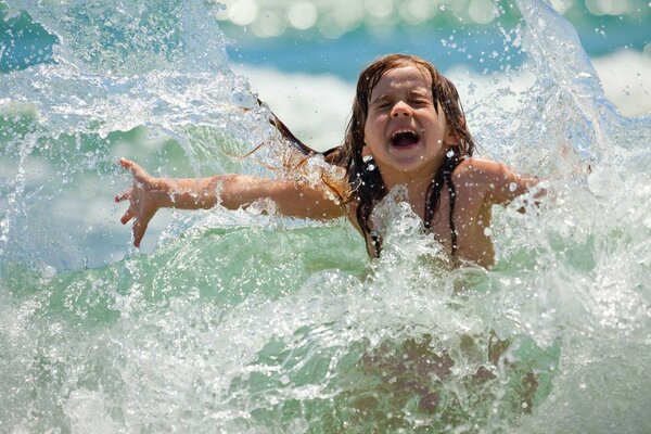 The girl splashes in clean water