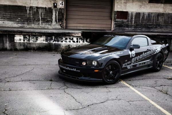 The car is burning down. Black Mustang