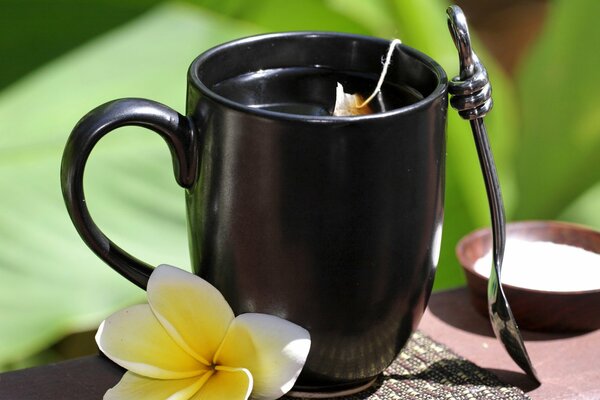 Fragrant tea in a black mug