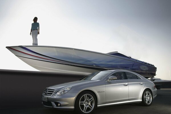 Mercedes on the background of a boat on which there is a girl