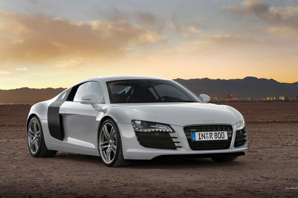 Hermoso coche blanco Audi en el fondo de las montañas