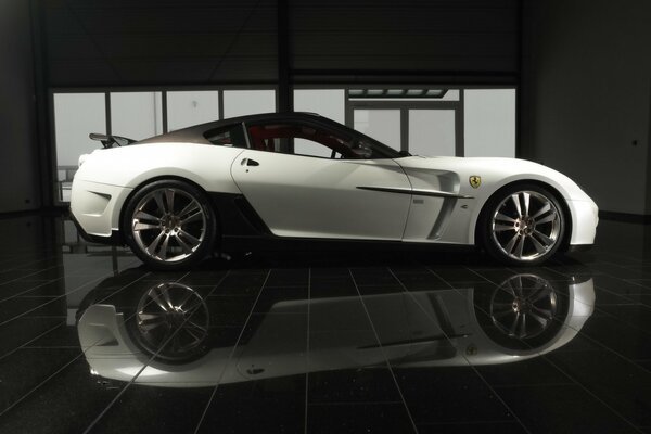 The silver Ferrari is reflected from the mirror surface