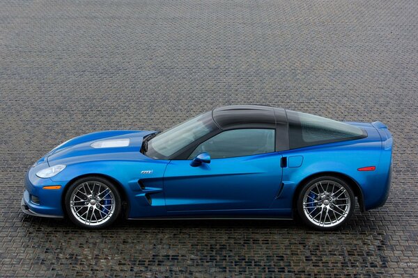 Beautiful blue corvette on a tile with a side view