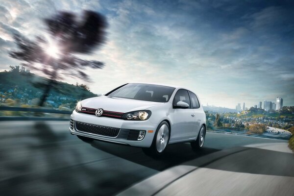 Stop frame white Volkswagen Golf GTI at speed on the road