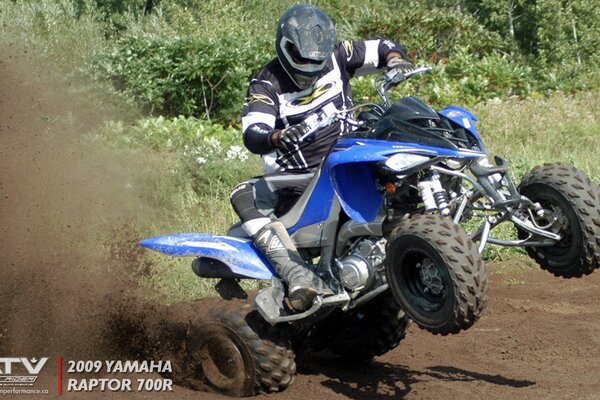 A man in a helmet rides an ATV