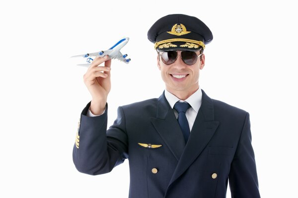 Smiling pilot with a toy airplane in his hands