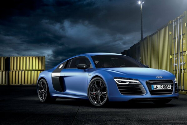 Blue audi with headlights on