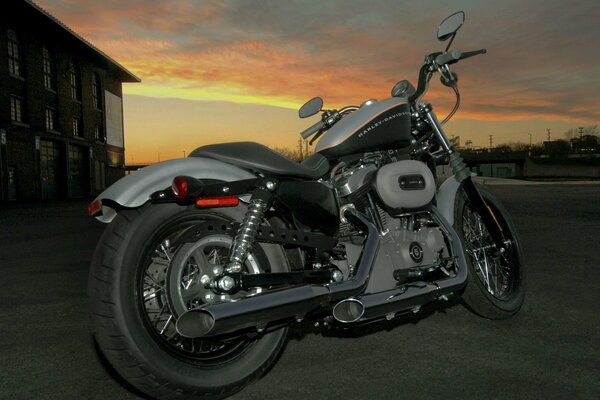 A powerful beautiful motorcycle is at sunset