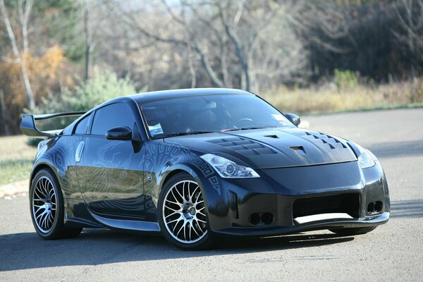 Nissan black car with a pattern on the hood