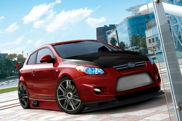 Red KIA with black hood cover