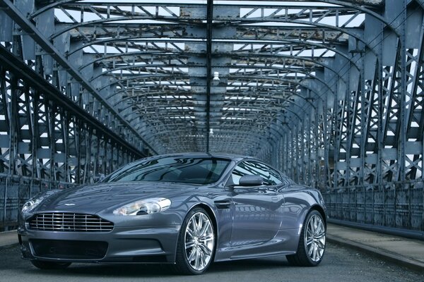 A sparkling Aston Martin on the background of an urban structure