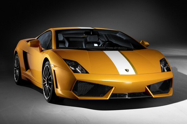 A yellow Lamborghini car stands on a gray background