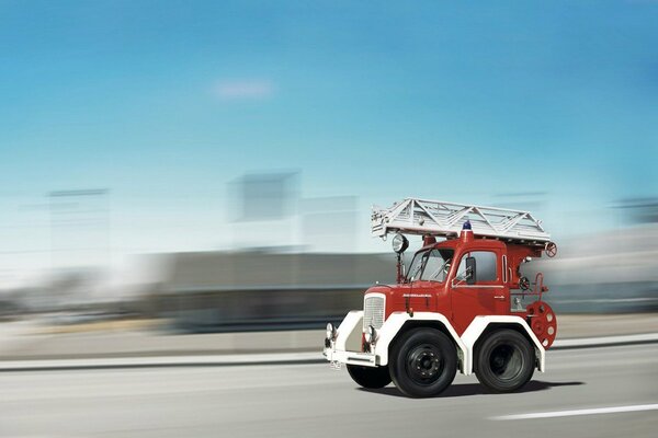 A small fire truck. Driving on the road