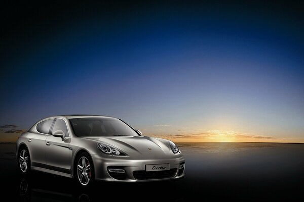 Silver Porsche on the background of a beautiful sunset