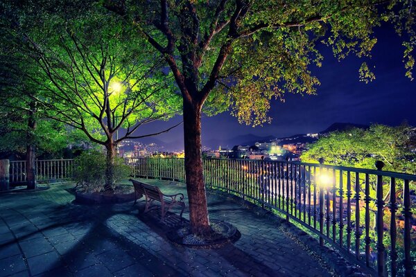 Night park with lights and fence