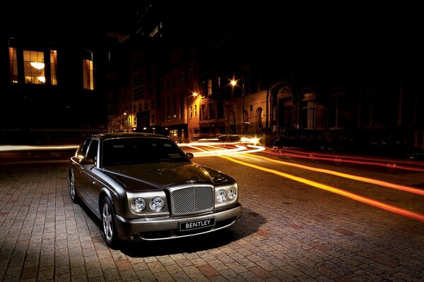 There is a Bentley under the beam of a flashlight