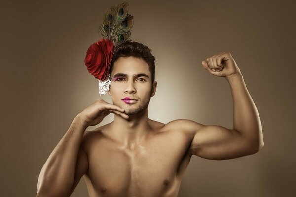 Male model in makeup with a flower