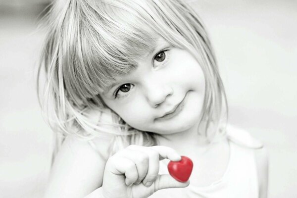 Black and white photo of a girl with a bright red heart