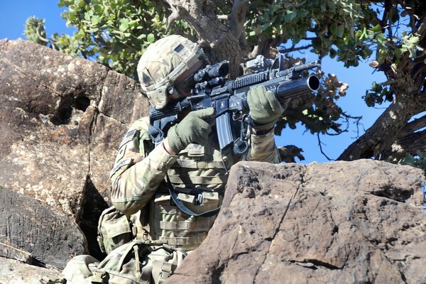 A soldier aims a machine gun at the enemy