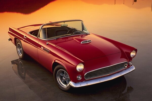 The red retro convertible reflects beautifully at sunset