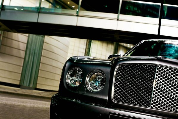 A chic Bentley on the background of a pedestrian bridge