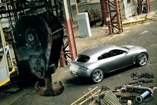 Grey jaguar in the workshop under the crane