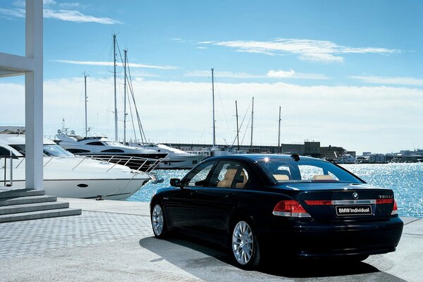 BMW on the background of beautiful moored yachts on the water