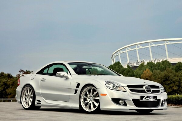 White tuned Mercedes on the playground