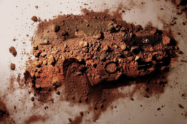 A rusty crumbling car on a flat surface