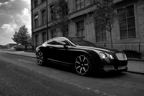 Beautiful black car on the background of the house