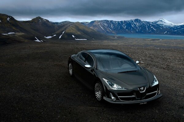 Black Peugeot near a mountain lake