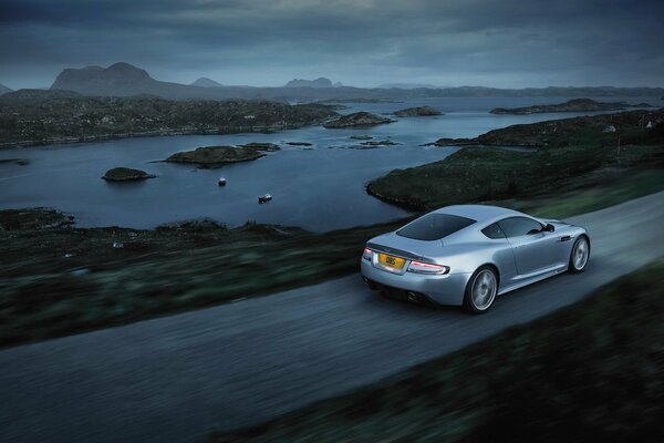 Grey aston-martin rides on the road