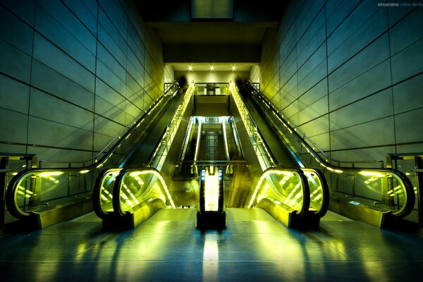 Unusual greenish lighting of an empty escalator