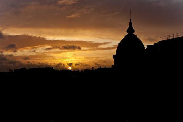 Shadows of the building on the background of a cloudy sunset