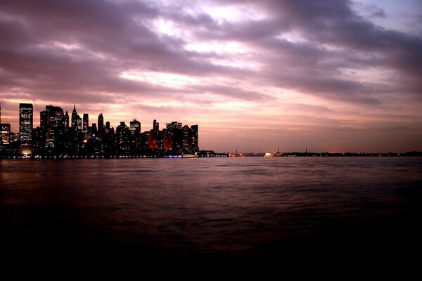 The sea illuminated by the lights of the evening city