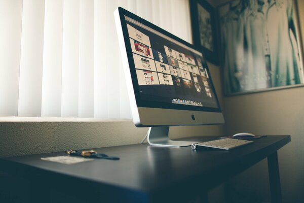 Apple monitor on a black table