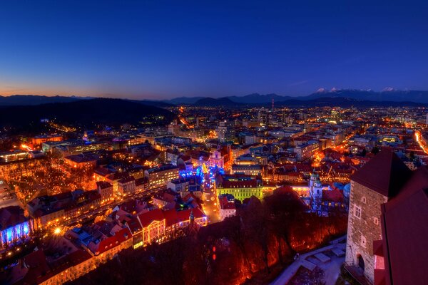 View of the night city from the window of a medieval castle