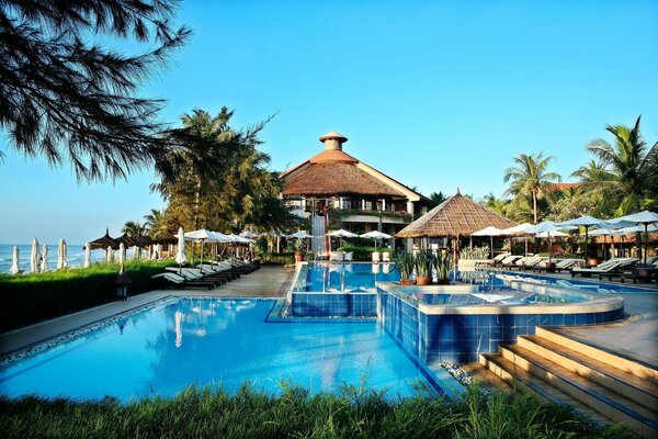 Hotel with a swimming pool, sun beds and a bar