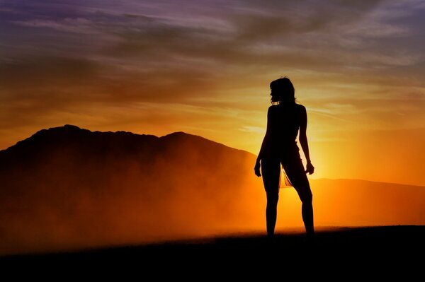 Silhouette of a girl against the sunset