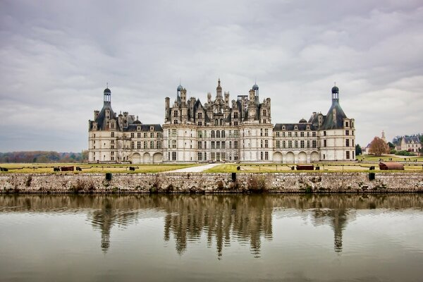 France castle in the clouds, sky in the water