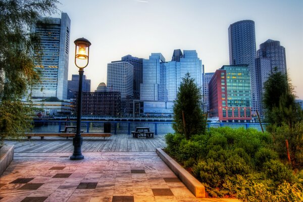 A lantern in a Boston park on the background of buildings