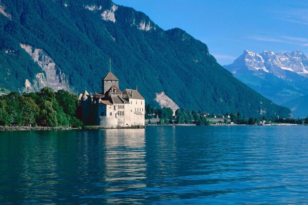 Hermoso castillo junto al lago azul entre las montañas